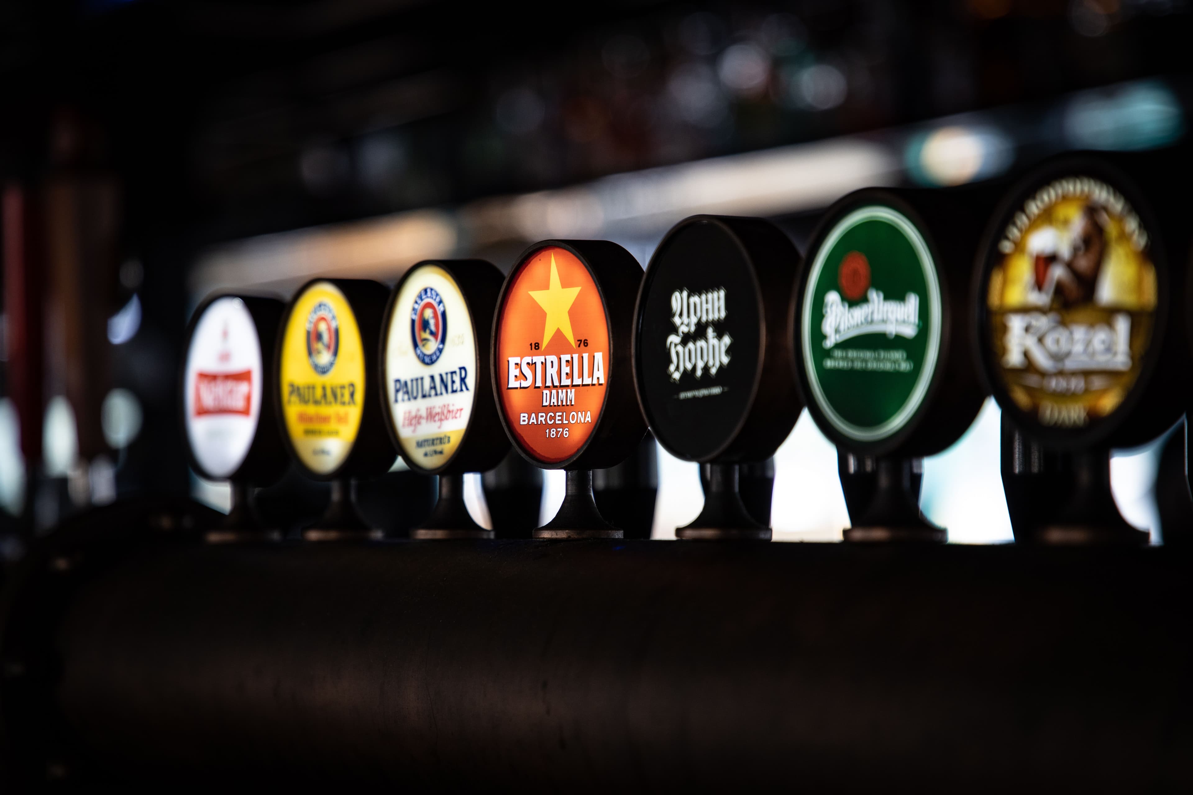 Craft beer festival with crowd holding pint glasses outdoors