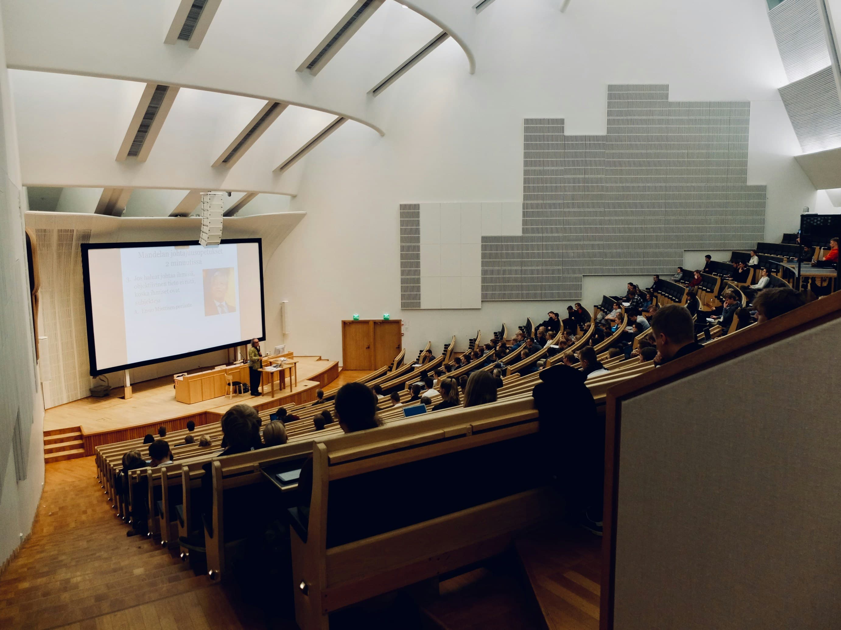 University lecture hall with presenter on stage