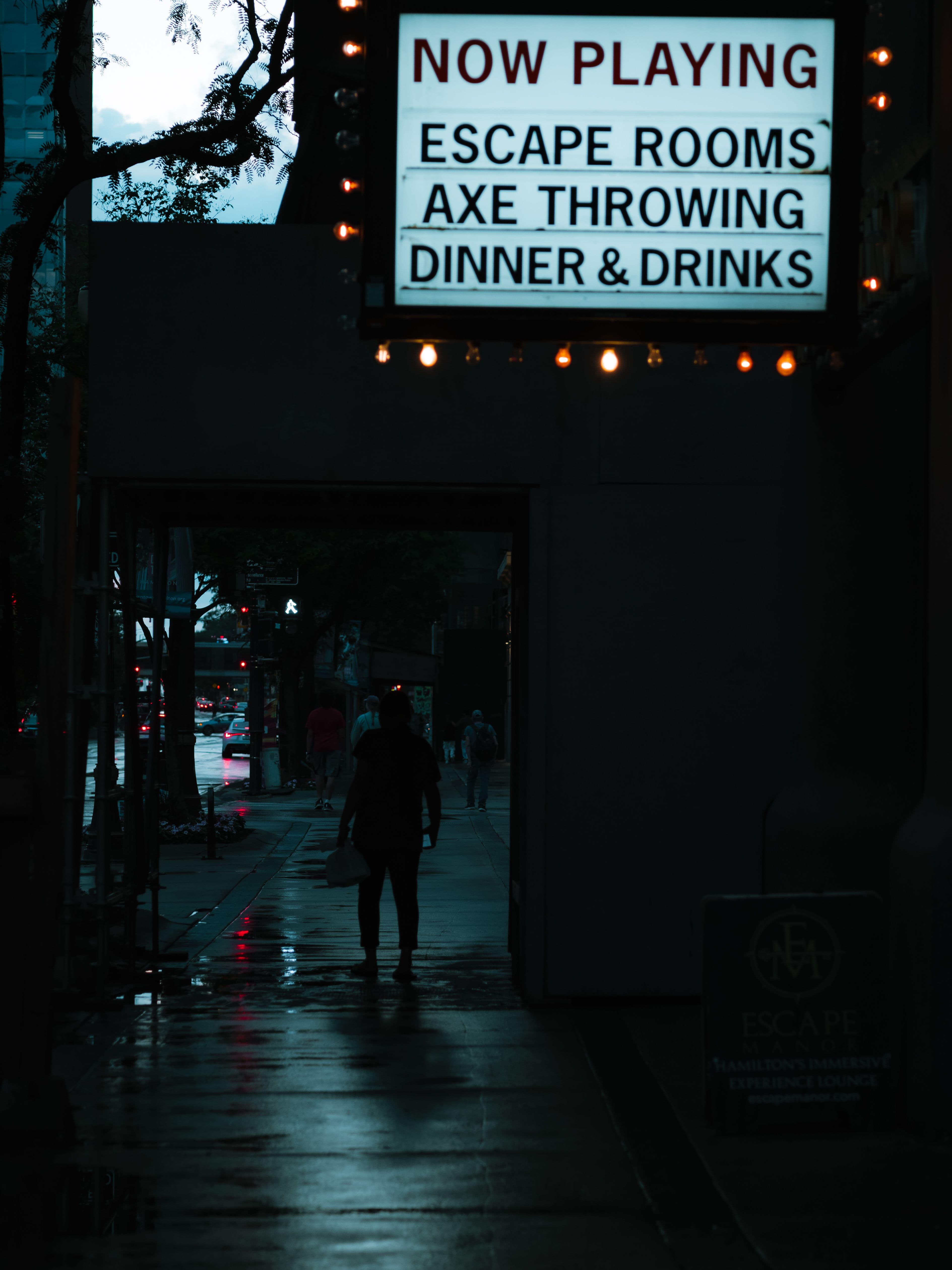 Group of players entering a dimly lit escape room